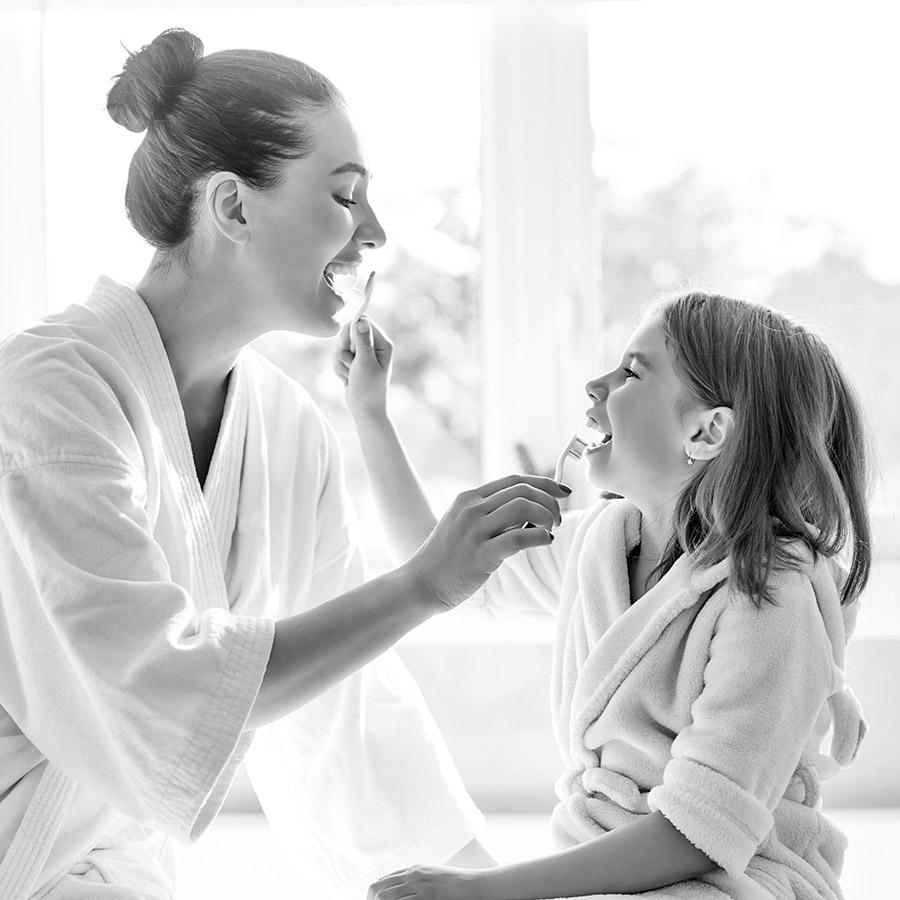 A mother and daughter caring for their smiles